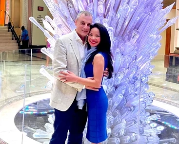 ME-LIPS founder Melinda Bui and her husband together in front of a glass sculpture