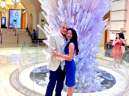 ME-LIPS founder Melinda Bui and her husband together in front of a glass sculpture